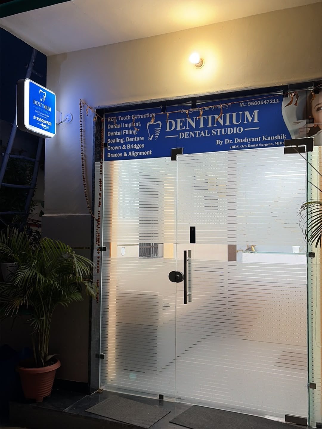 Entrance of Dentinium Dental Studio lit up in the evening