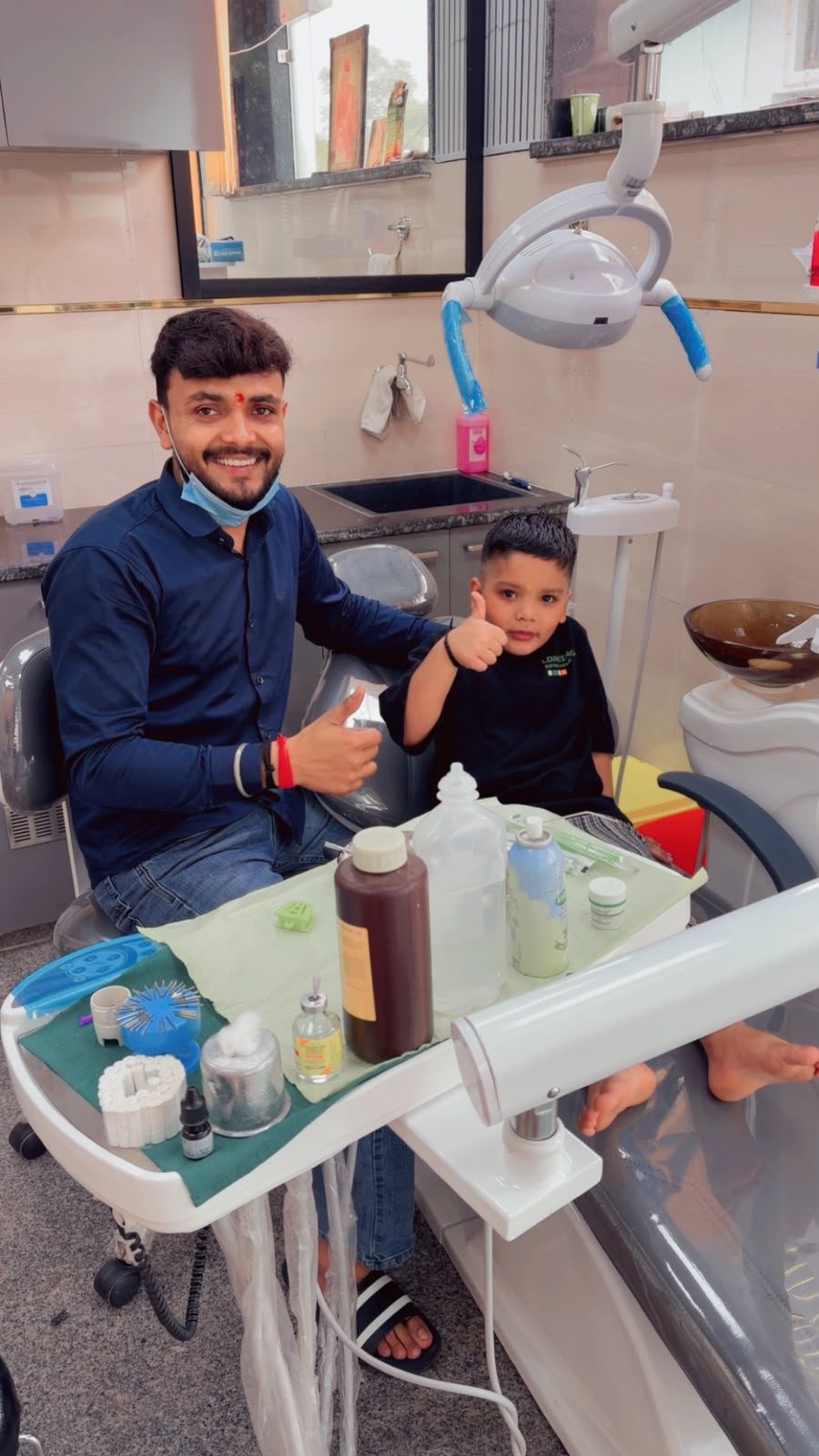 Dr. Kaushik and a young patient giving a thumbs up after his visit